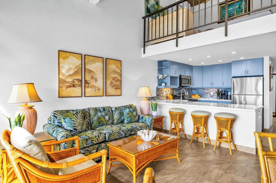 Unit 1: A cozy and comfortable spot to relax! The living room is furnished in a laid-back, tropical style-perfect for unwinding after a sun-filled day