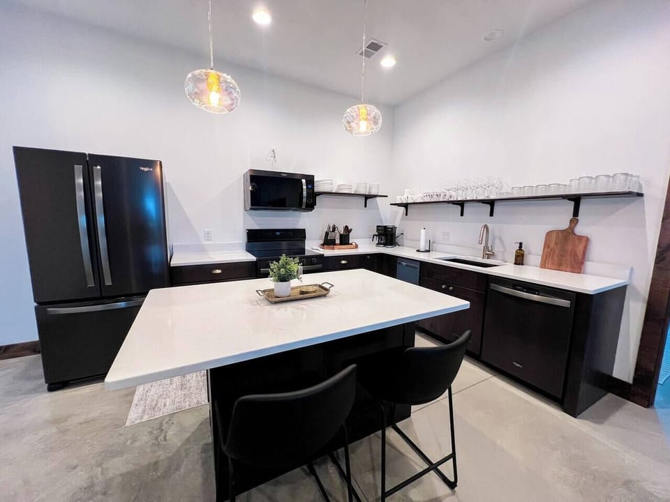 Whip up a culinary masterpiece in style with sleek black stainless steel appliances and spacious island!