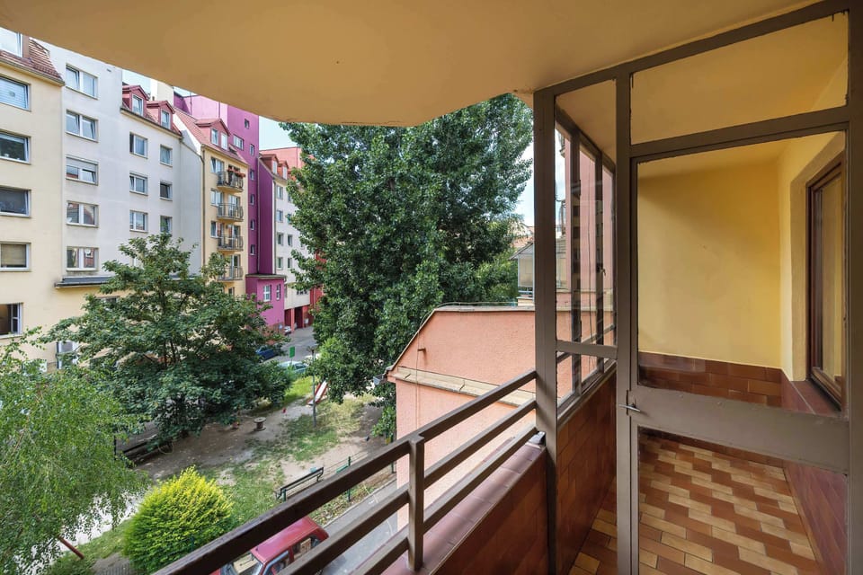 The balcony provides a tranquil spot for enjoying a book.