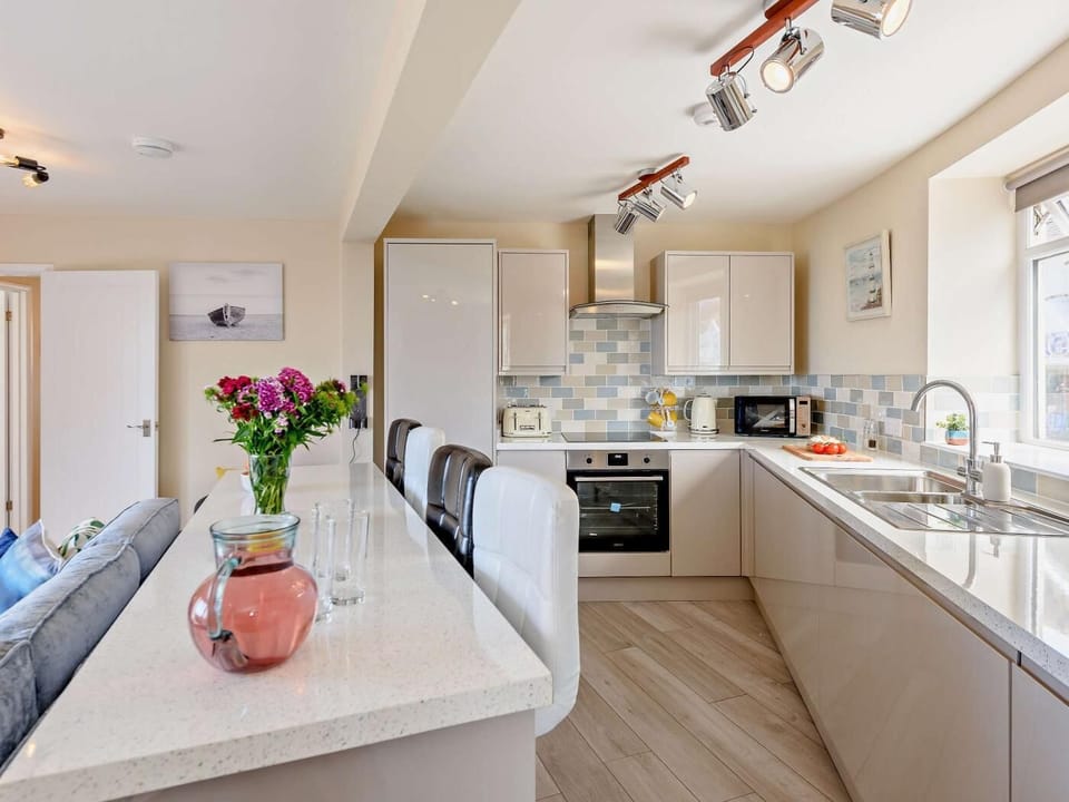 A clever use of space provides a well-appointed kitchen and breakfast bar