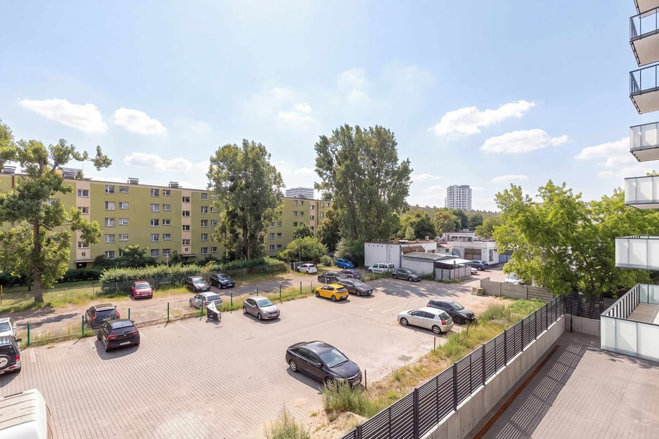 A pleasant view of the surrounding green areas and neighborhood. The nearby open spaces create a peaceful atmosphere.
