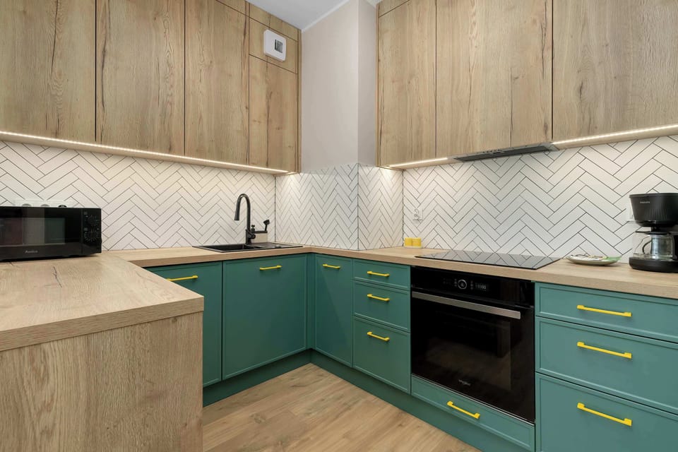 A contemporary kitchen with plenty of workspace and storage. Prepare your favorite dishes with ease during your stay.