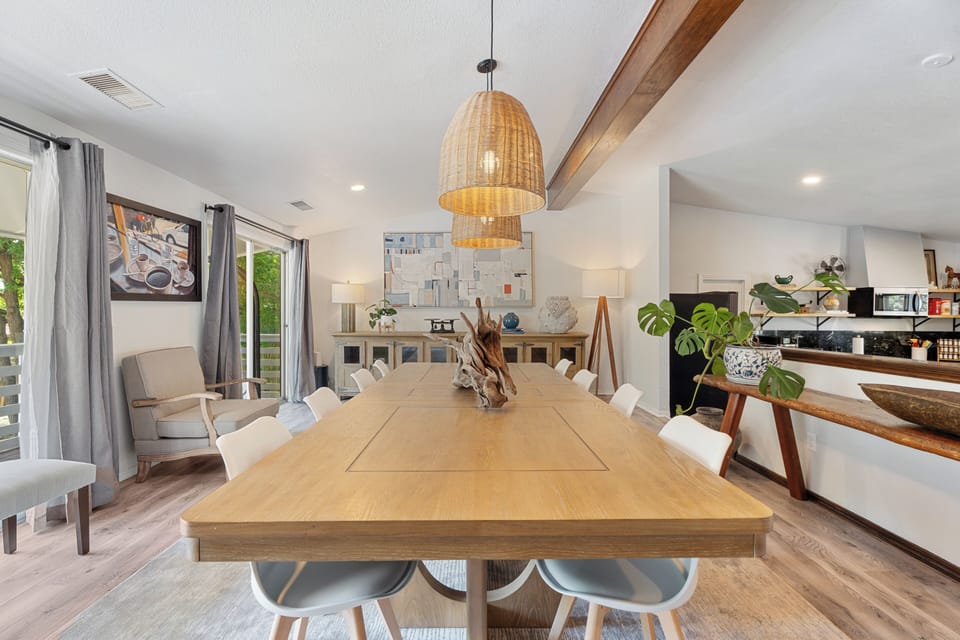 Dining table — seats eight to ten under the beamed ceiling.