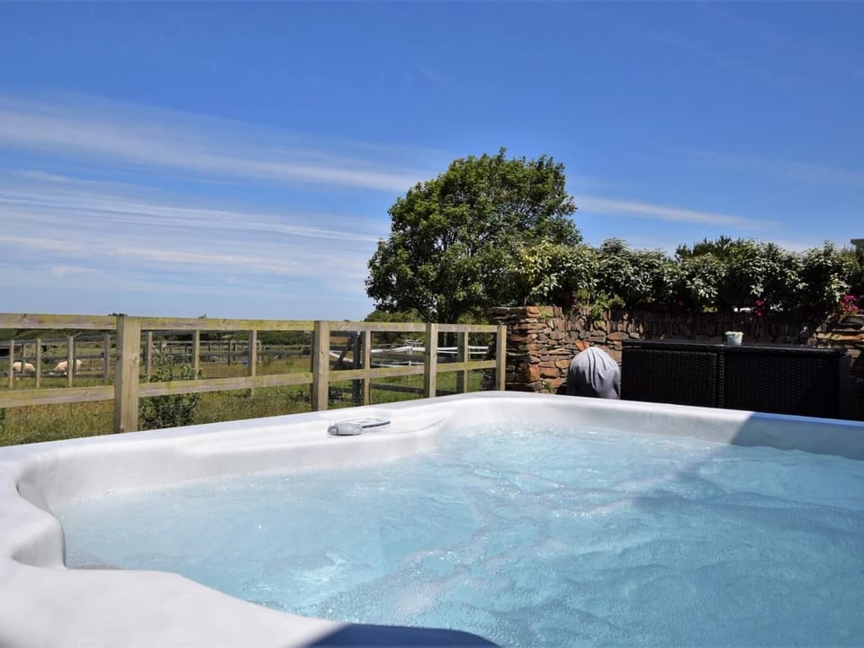 Relax in the hot tub and enjoy the stunning countryside and out to sea views