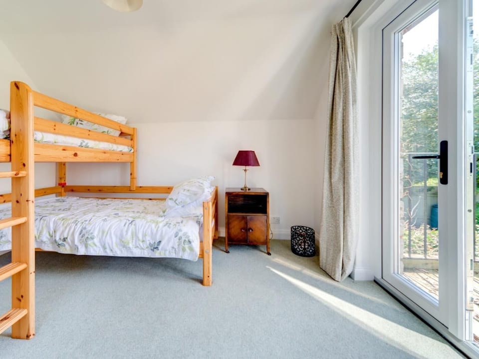 Bunk bedroom with French doors opening onto a delightful balcony for enjoying a morning cup of coffee with views of the castle
