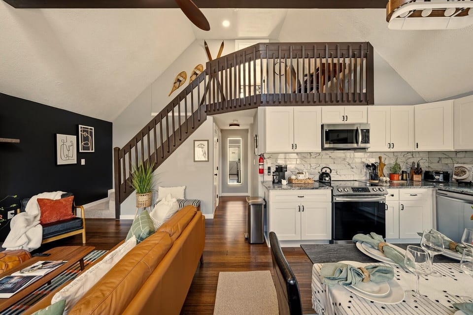 Stylish loft-style living with vaulted ceilings and a modern full kitchen