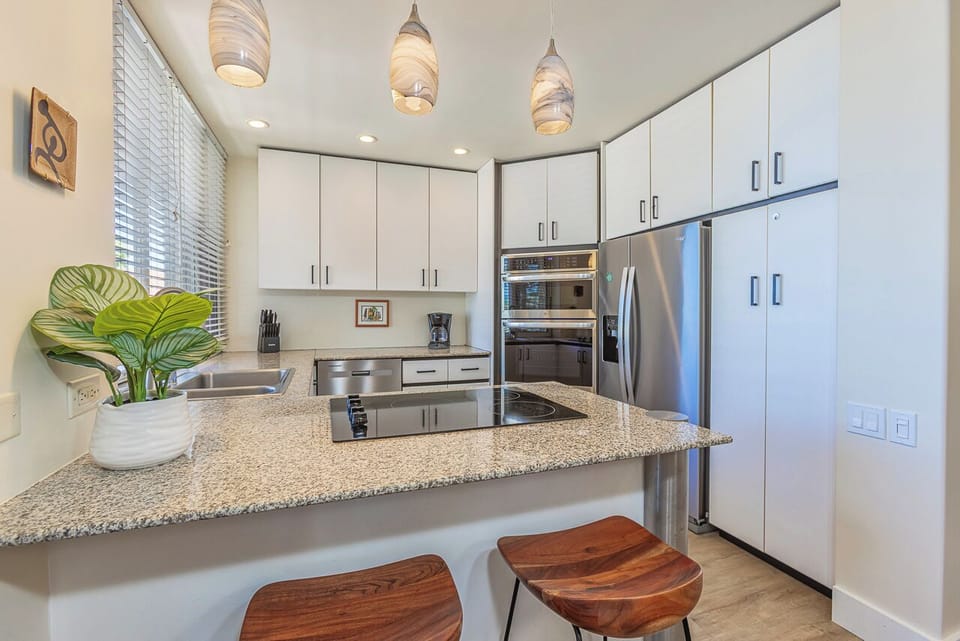 Your modern kitchen features stainless steel appliances, and stylish pendant lighting.