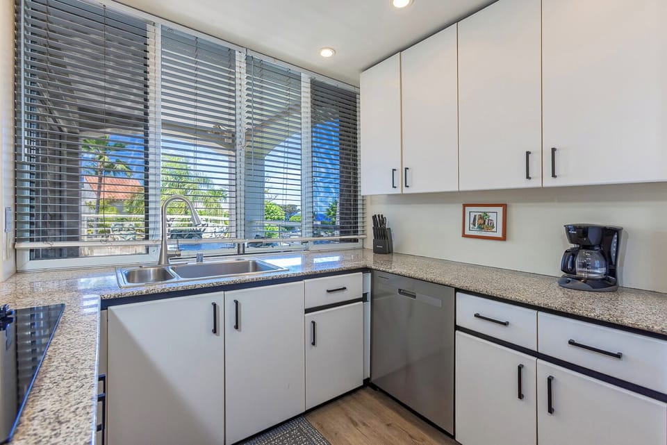 Natural light floods in through large windows, offering pleasant views of the surrounding area.