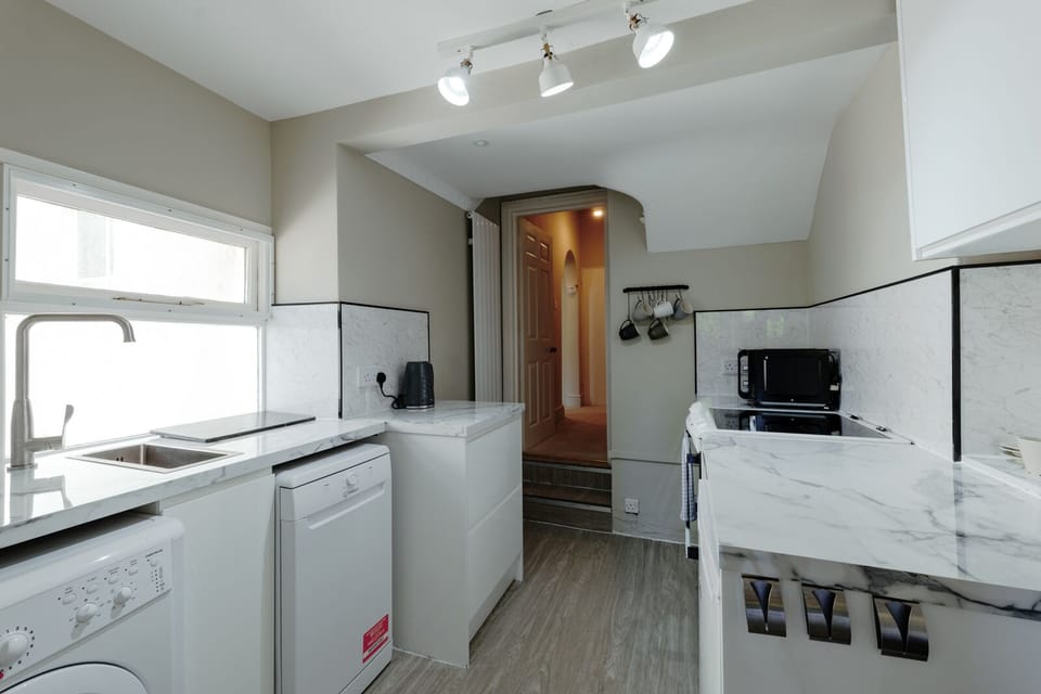 Fully equipped kitchen featuring a dishwasher, washer and dryer
