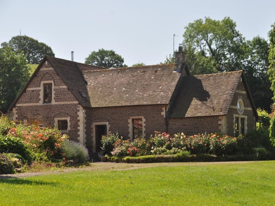 The country home is surrounded with established floral borders