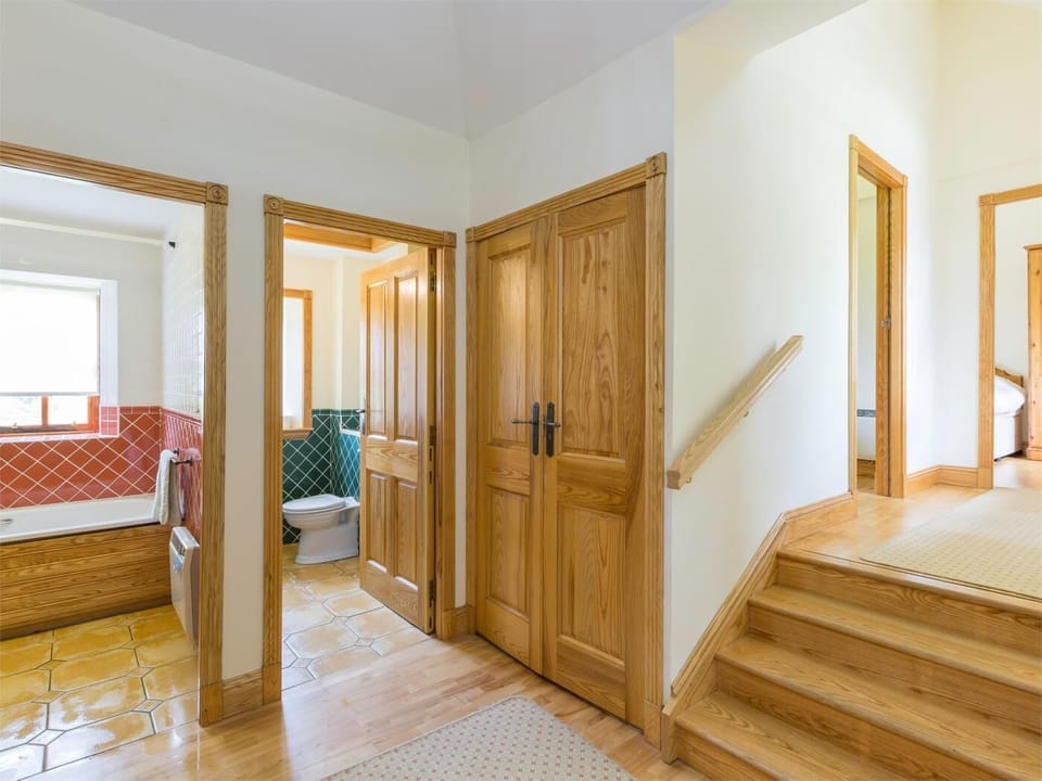 Steps leading down to bedrooms and bathroom