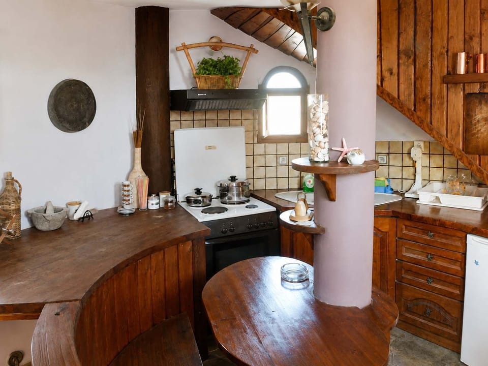 A warm, rustic kitchen with wooden finishes and everything guests need for making meals, morning coffee, or a quiet night in after exploring