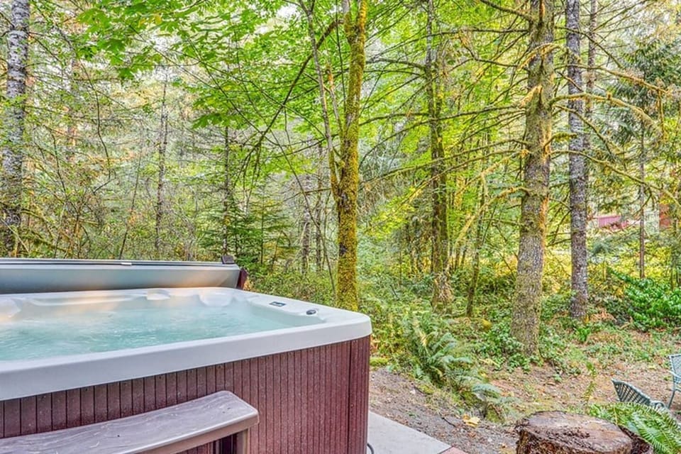 Covered hot tub looks out to our  acres and acres of wooded property.