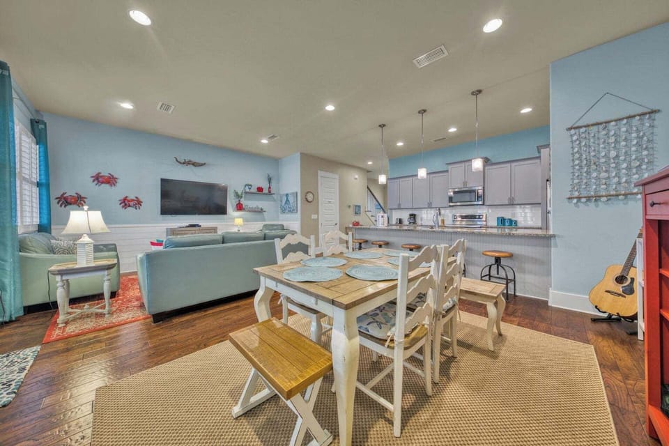 Relax in your open-concept living space with coastal charm. Enjoy the fully equipped kitchen, comfortable seating, and beach-themed decor that makes you feel instantly at home.