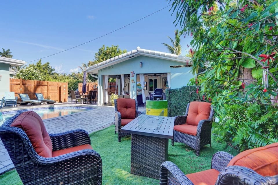 Outdoor lounge set surrounded by tropical plants.