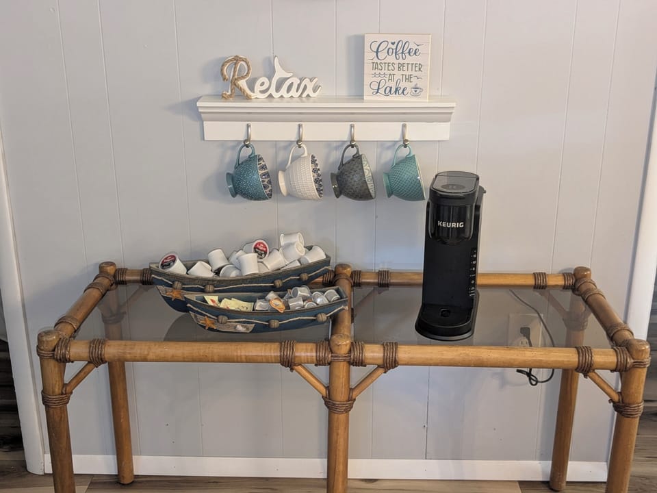 Cozy lake-inspired coffee station with Keurig, mugs, and stocked pods