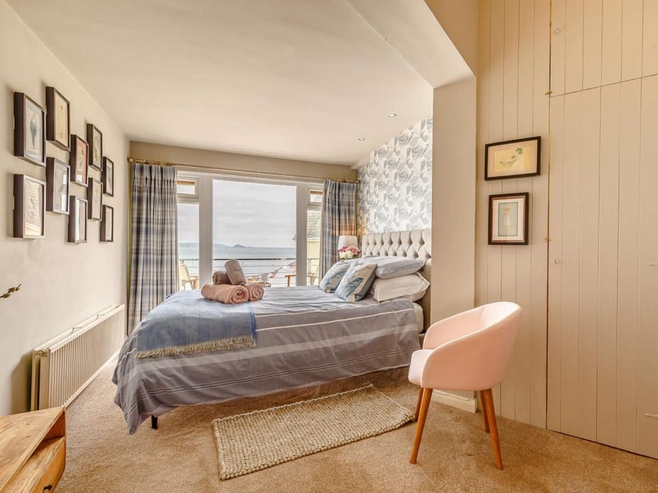 Master bedroom looking out to sea with double doors on to balcony 