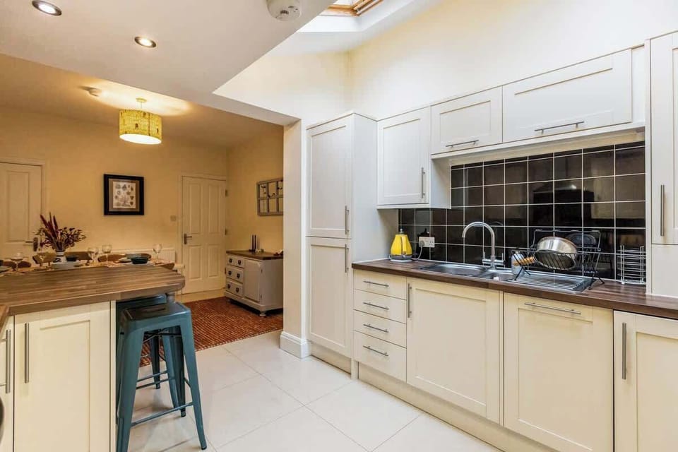 Fully equipped kitchen with modern appliances and a skylight that floods the space with natural light — perfect for cooking and socialising