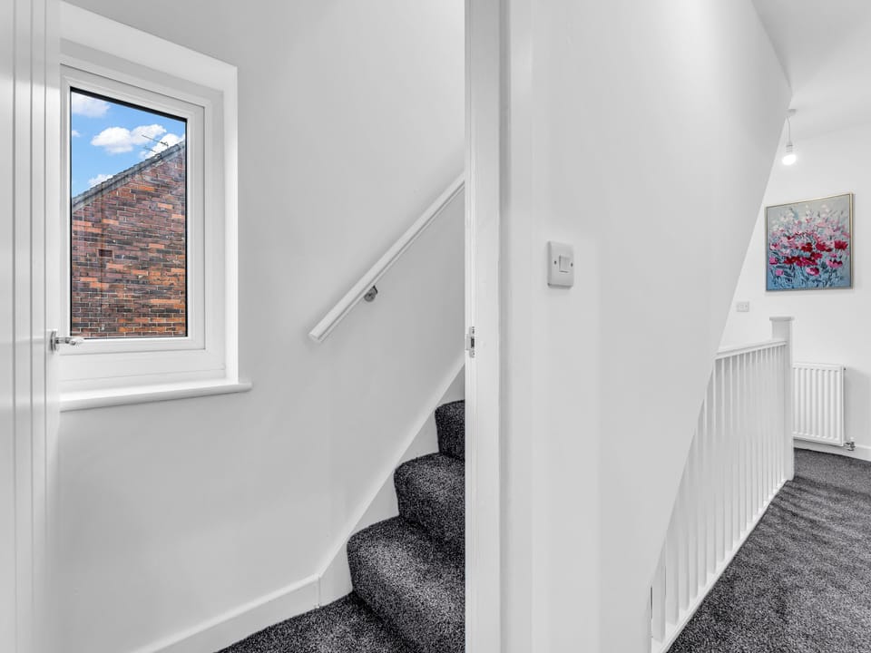Bright modern landing with natural light and fresh, clean finishes