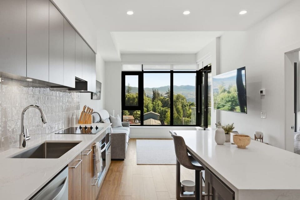 Full kitchen with island and stainless steel appliances.