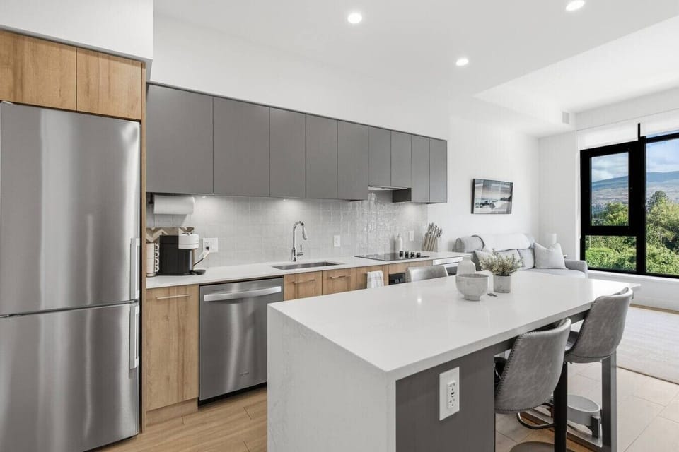 Modern kitchen with cooktop, oven and microwave.