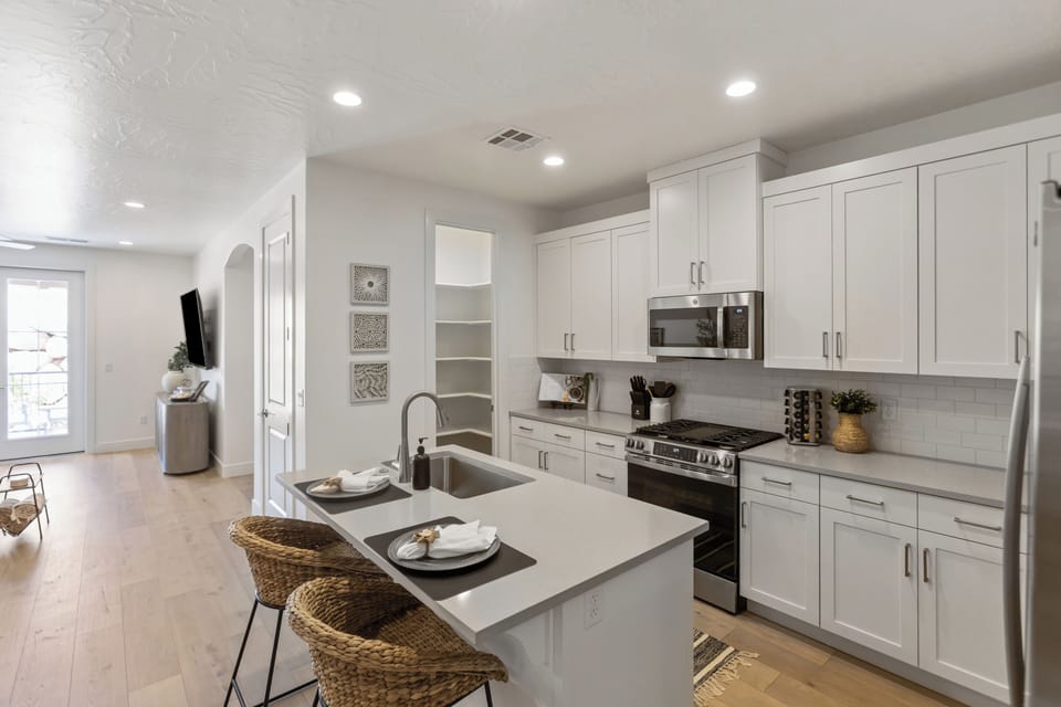 Bright modern kitchen with island seating and sleek stainless appliances