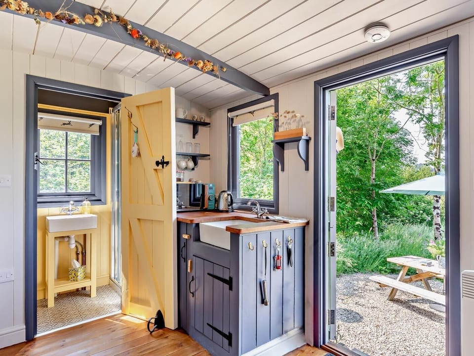 Kitchen area with door leading to the shower room and WC