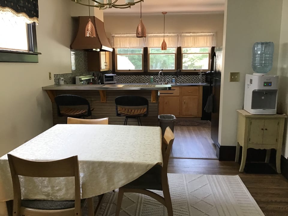 Dining area table that extends to seat 8. Extra chairs under bar behind door.