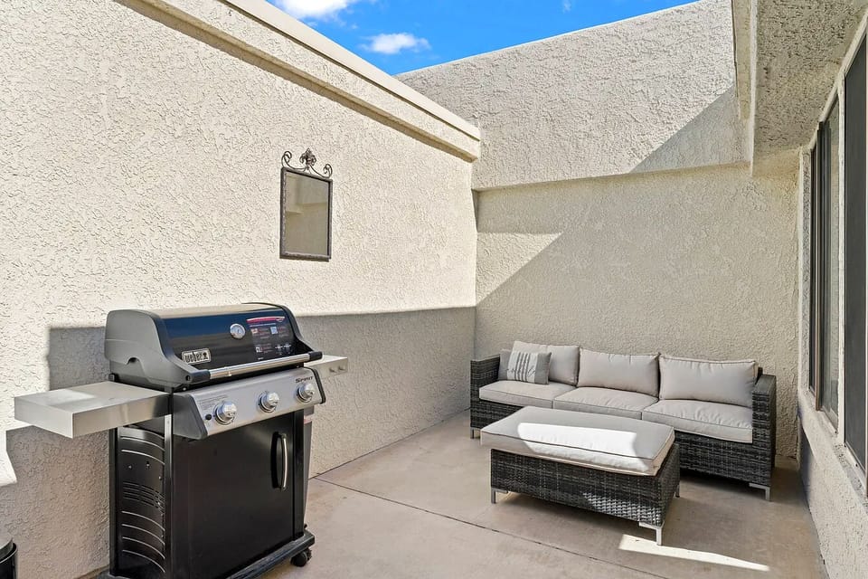 Fire up the grill or lounge in style on your private, walled patio. Features a premium stainless steel gas BBQ and a comfortable outdoor sectional sofa perfect for relaxing under the sun.