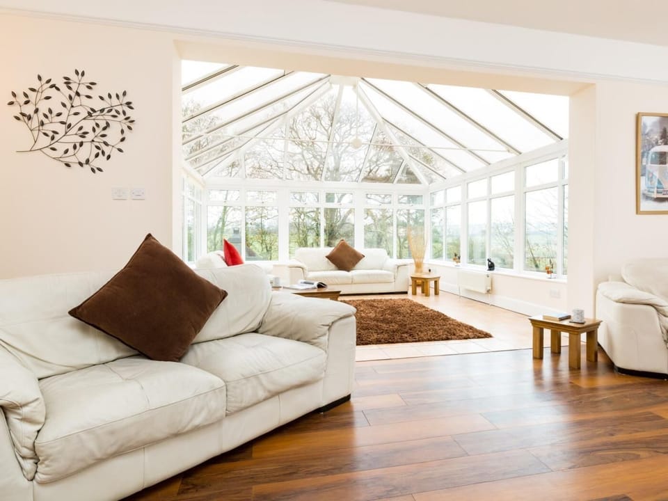 Second lounge leading to conservatory with river views