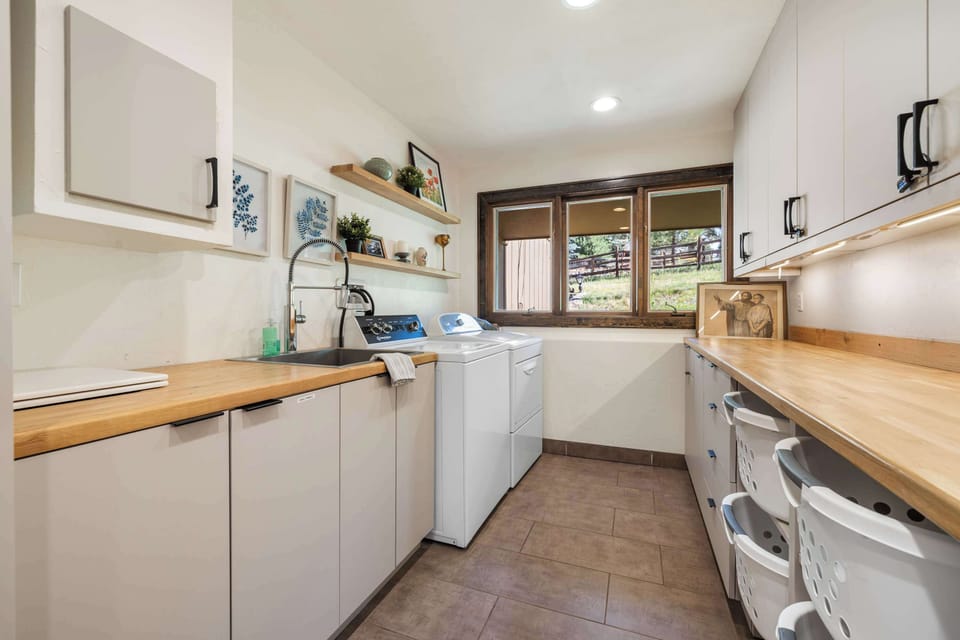 Full size washer and dryer with plenty of space in the laundry room.

