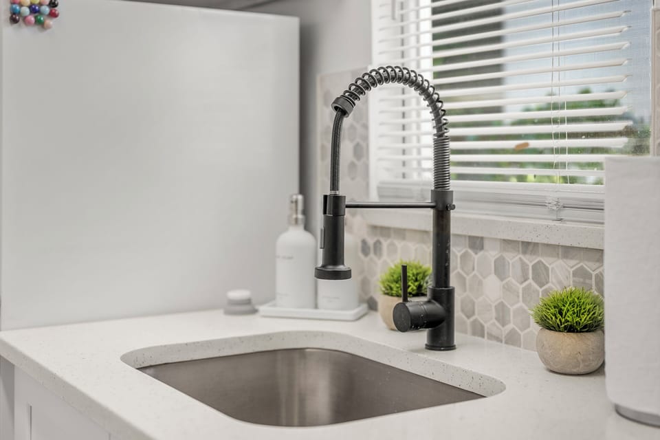 Fresh and spotless workspace with a modern sink and plenty of room for meal prep and cleanup.