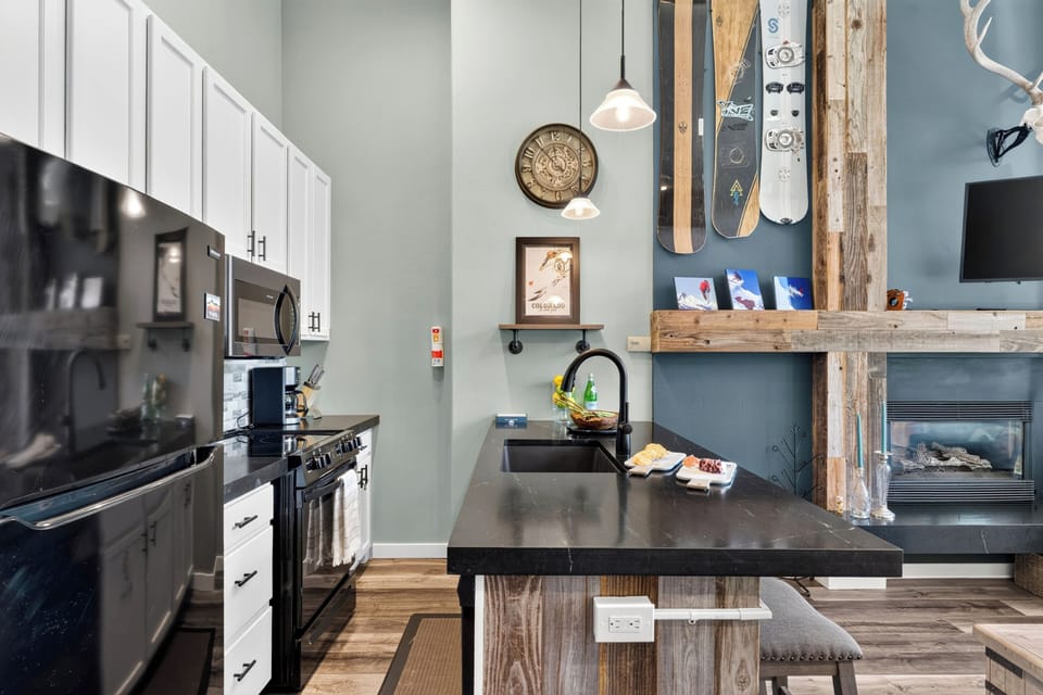 Thoughtfully designed kitchen layout, complete with premium dark appliances and playful ski-lodge decor.