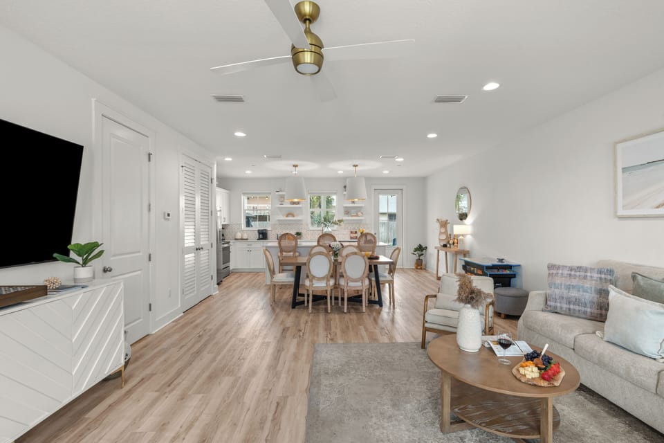 Bright open-concept living, dining, and kitchen space with coastal style and plenty of room to gather.