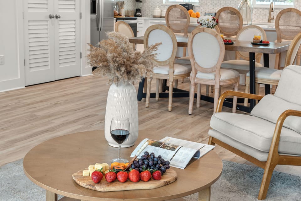 Bright open-concept living, dining, and kitchen space with coastal style and plenty of room to gather.