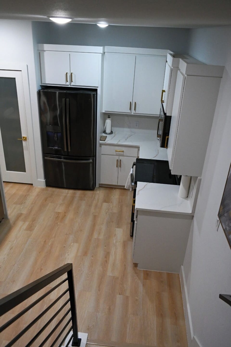 Bright modern kitchen with white cabinets and sleek black appliances