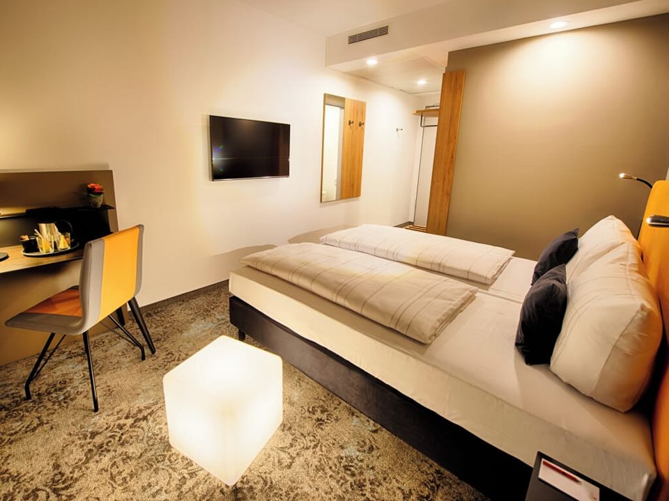 Unwind after adventures with TV, desk, and crisp linens.
