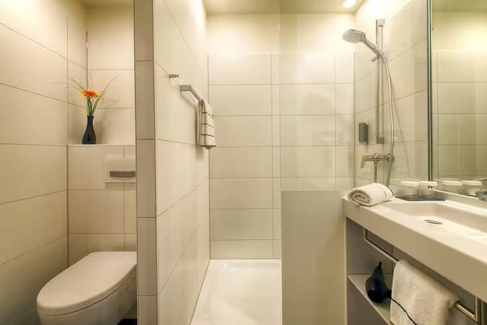 Refresh after a long day in the sleek walk-in shower.