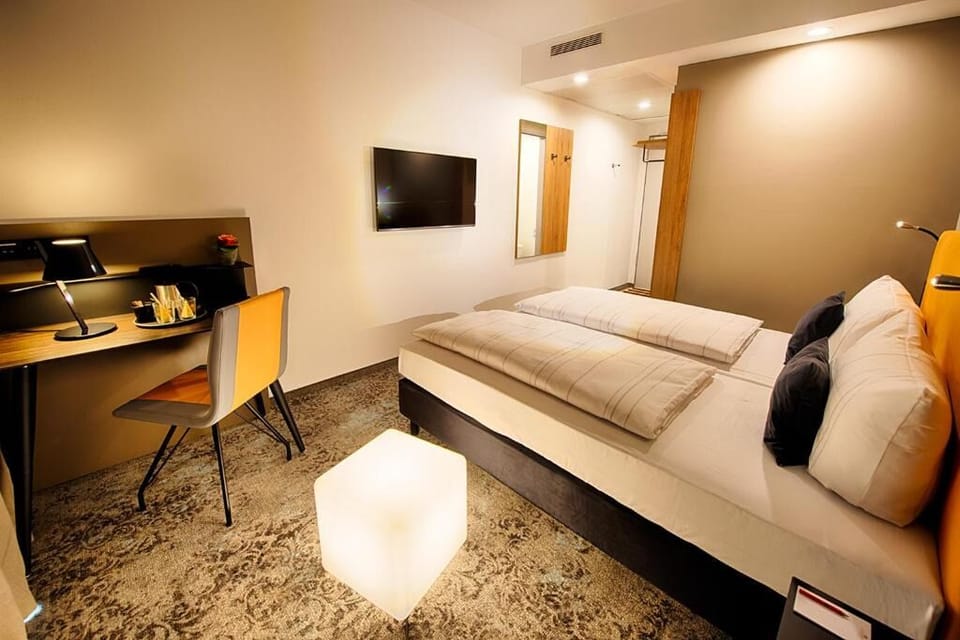 Unwind in a cozy bedroom with desk and TV.