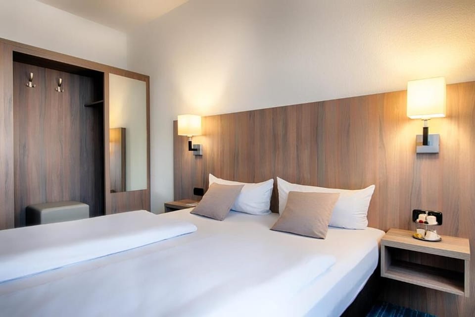 Unwind in crisp linens under warm, calming bedside lights.