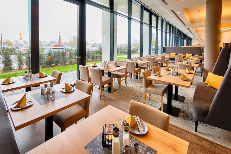 Dine beside floor-to-ceiling windows with airy, open views.