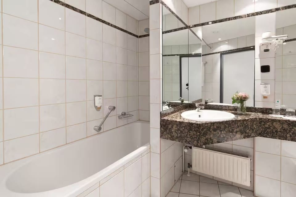 Refresh in a spotless, tiled bathroom with generous vanity space.