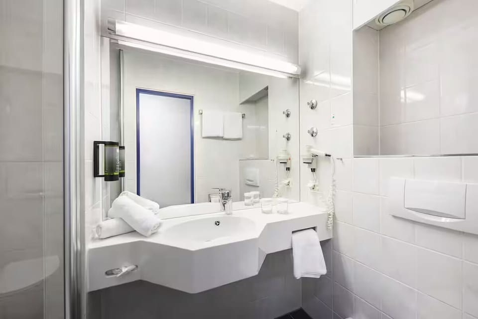 Refresh quickly at the spotless vanity with bright mirror lighting.