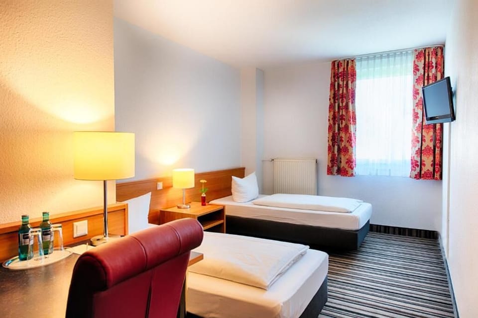 Unwind after adventures in a bright, simple twin room.