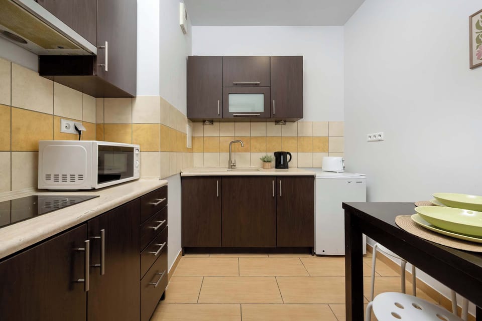 Fully equipped kitchen with modern appliances, generous countertop space, and a dining table.