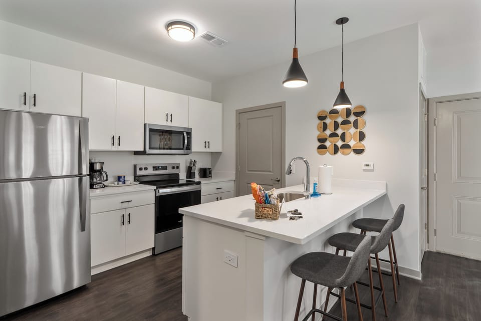 Modern full kitchen with lots of counter space, cabinets, and all the kitchenware you need to cook and serve a meal! 