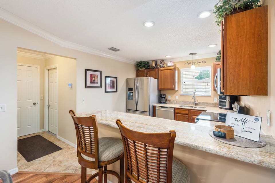 Hallway to the Left Provides a Pantry and Access to the One Car Garage