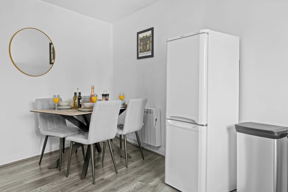 Bright modern dining nook with seating for four and full-size fridge