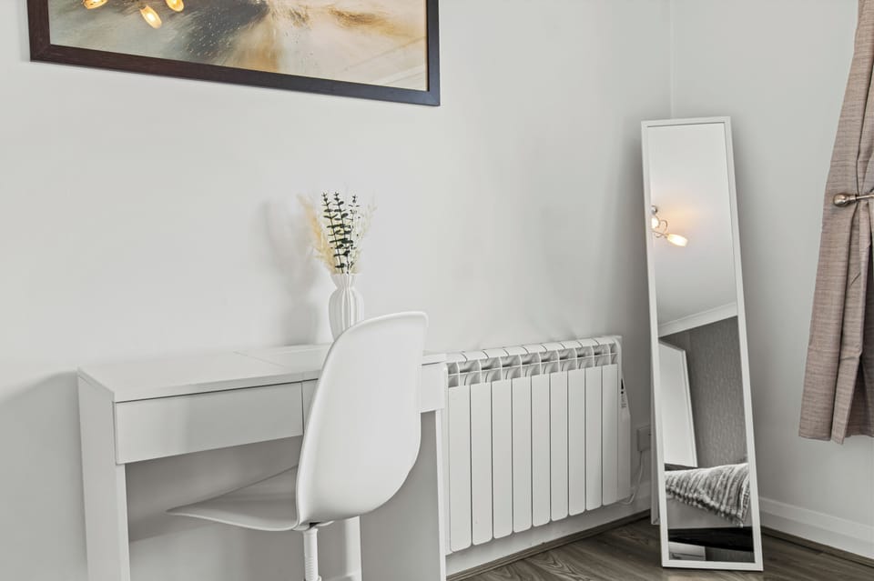 Bright minimalist desk nook with full-length mirror and modern style