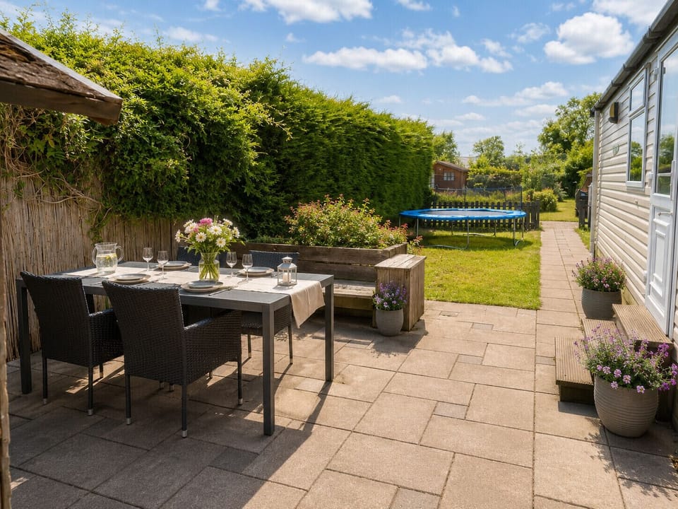Spacious garden with cozy seating area and parasol